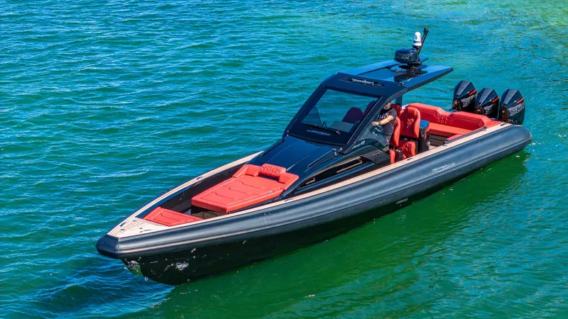 Slide: The Image of 2025 Technohull Omega 47 boat with sleek design and red seating on blue water. - 7