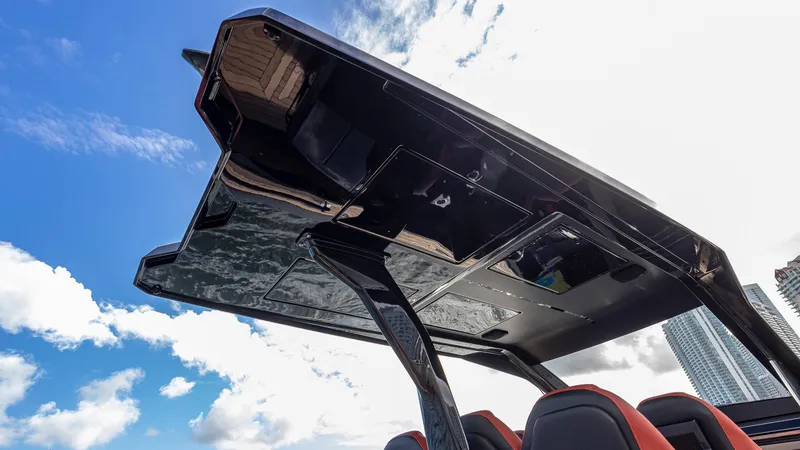 Slide: The Image of Technohull Omega 47 (2025) boat canopy against blue sky and clouds. - 8
