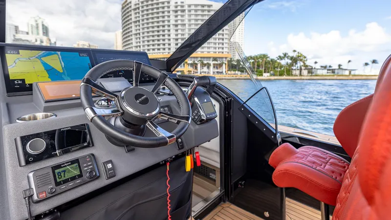 Slide: The Image of Technohull Omega 47 (2025) cockpit with modern controls and waterfront view. - 9