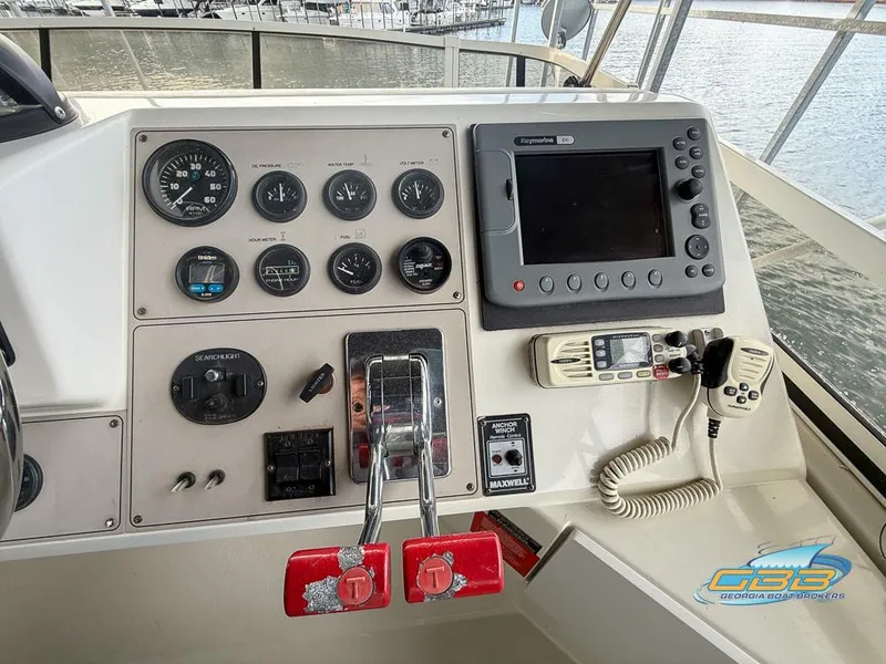 Slide: The Image of 1998 Carver 405 Aft Cabin helm with gauges, controls, and navigation equipment. - 30