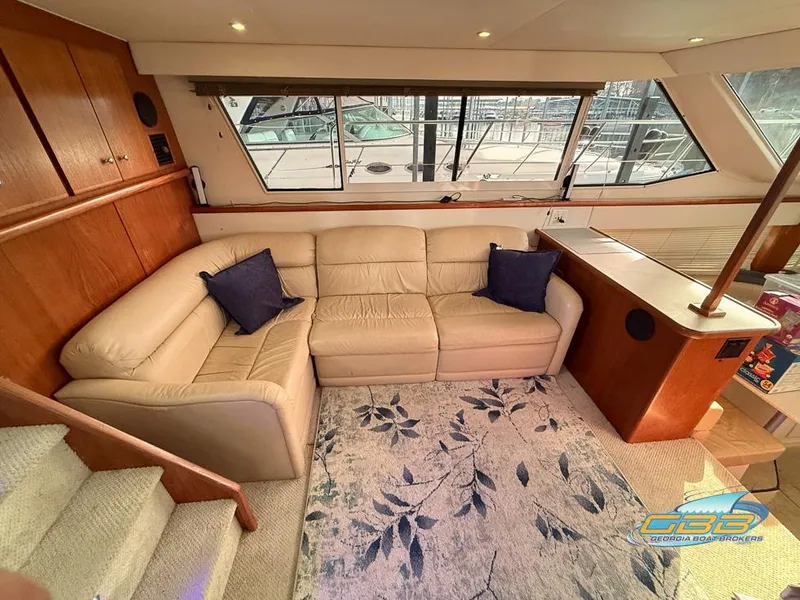 Slide: The Image of Luxurious 1998 Carver 405 Aft Cabin interior with beige sofa and nautical decor. - 33
