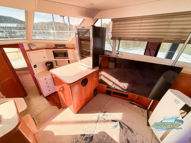 Slide: The Image of Interior of 1998 Carver 405 Aft Cabin yacht with modern amenities and large windows. - 37