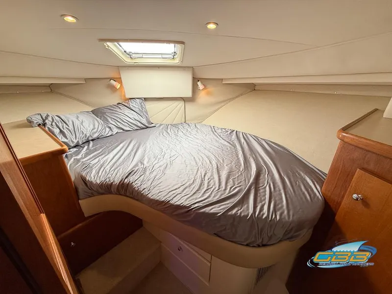 Slide: The Image of Cozy bedroom in 1998 Carver 405 Aft Cabin yacht with skylight and wood accents. - 40