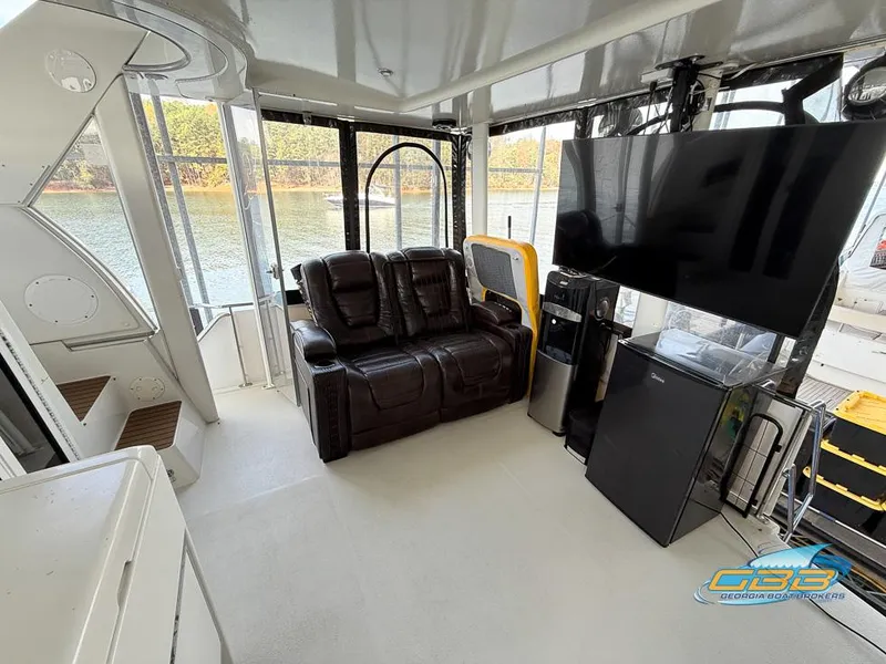 Slide: The Image of 1998 Carver 405 Aft Cabin interior with leather seating, TV, and appliances. - 43