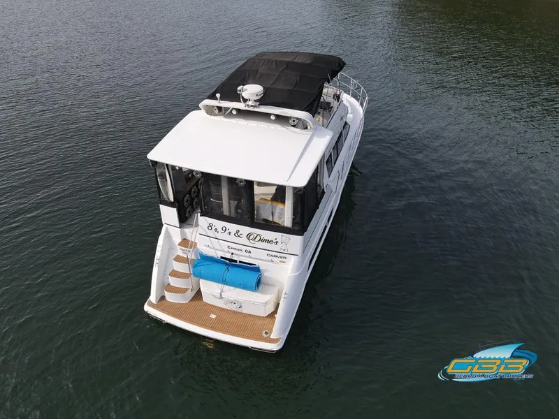 Slide: The Image of 1998 Carver 405 Aft Cabin boat on water, aerial view. - 13