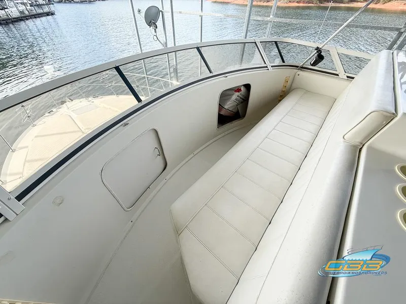 Slide: The Image of 1998 Carver 405 Aft Cabin boat interior with white seating and lake view. - 23