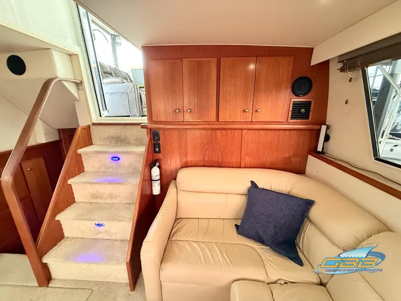 Slide: The Image of Interior of 1998 Carver 405 Aft Cabin with beige sofa and wooden cabinetry. - 41