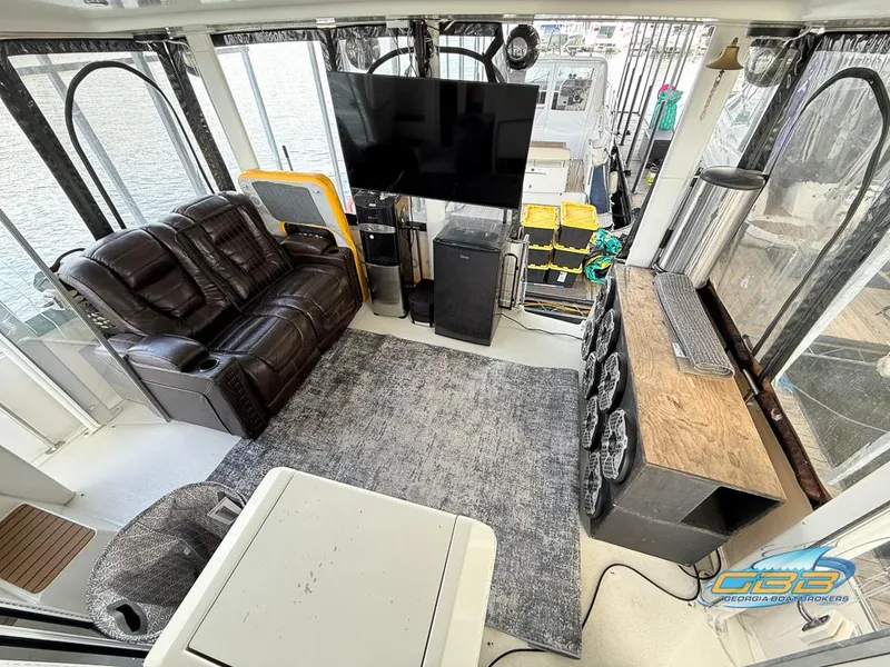 Slide: The Image of Interior of 1998 Carver 405 Aft Cabin with leather seating, TV, and modern amenities. - 42