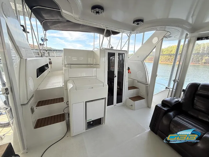 Slide: The Image of 1998 Carver 405 Aft Cabin interior with seating, steps, and water view. - 44
