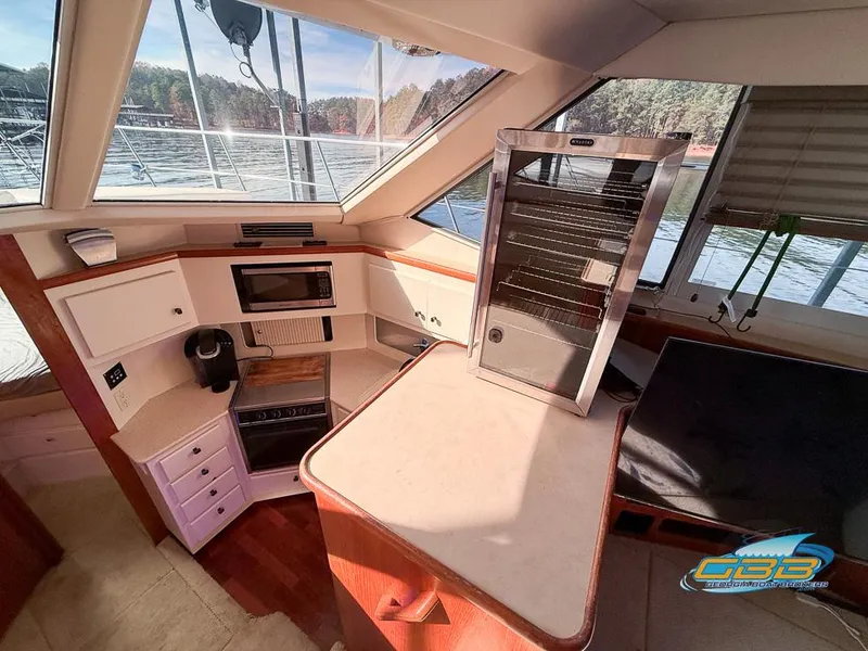 Slide: The Image of Interior of 1998 Carver 405 Aft Cabin yacht with kitchen and seating area. - 46