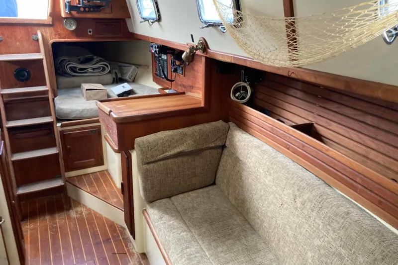 Slide: The Image of Interior of 1994 Pacific Seacraft 37 sailboat with wooden finishes and cozy seating area. - 10