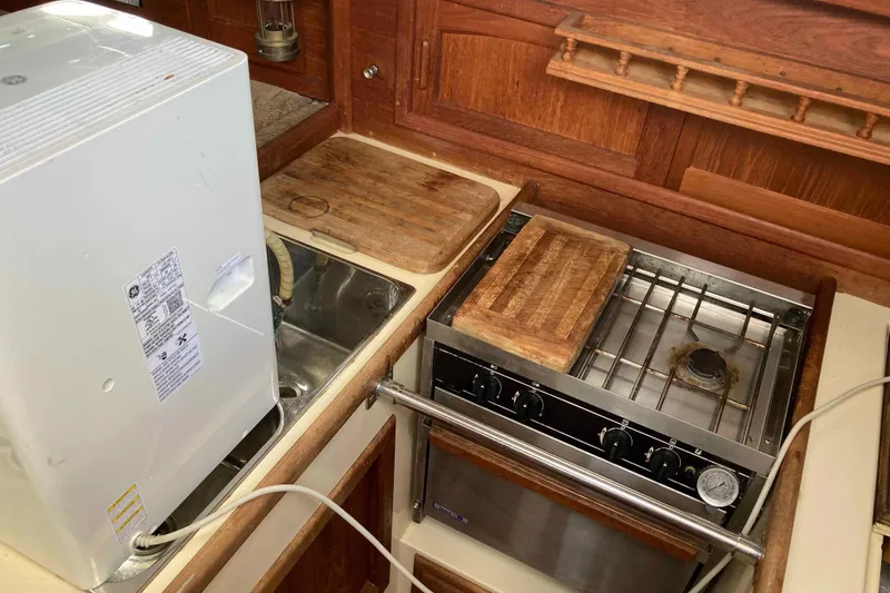 Slide: The Image of Galley kitchen in 1994 Pacific Seacraft 37 sailboat with stove and sink. - 13
