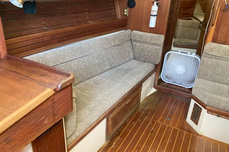 Slide: The Image of Interior of a 1994 Pacific Seacraft 37 sailboat with wooden finishes and cushioned seating. - 18