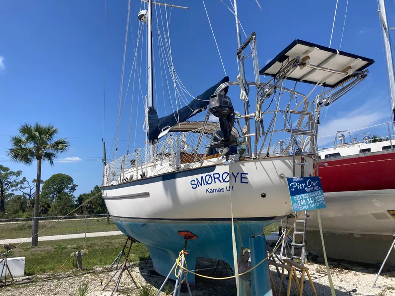 Slide: The Image of 1994 Pacific Seacraft 37 sailboat on dry dock, blue hull, white deck. - 2