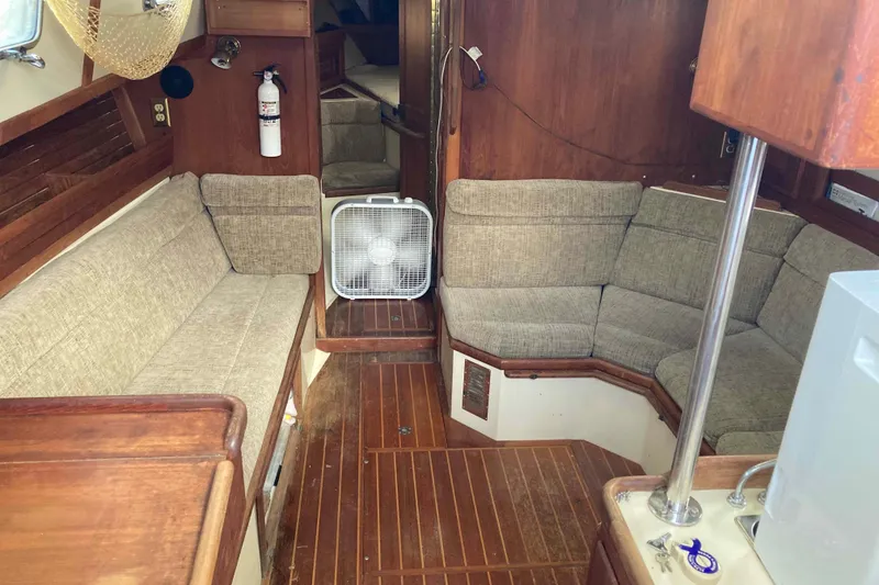 Slide: The Image of Interior of a 1994 Pacific Seacraft 37 sailboat with cozy seating and wooden finishes. - 7