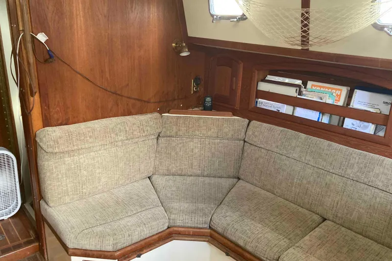 Slide: The Image of Cozy interior of 1994 Pacific Seacraft 37 sailboat with cushioned seating and wooden accents. - 8