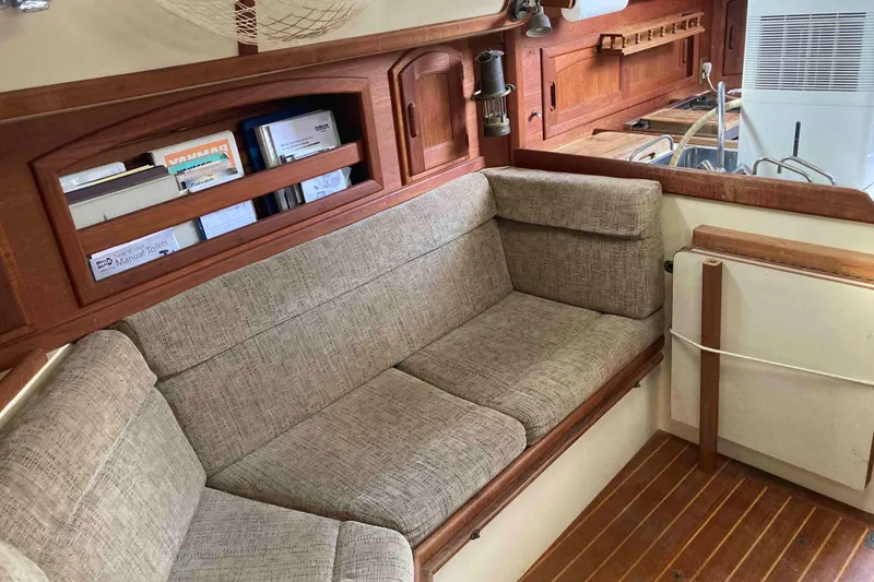 Slide: The Image of Interior of 1994 Pacific Seacraft 37 sailboat with cushioned seating and wooden cabinetry. - 9