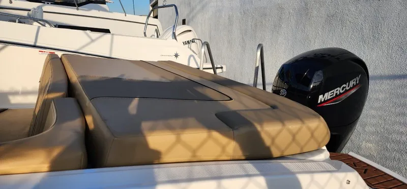 Slide: The Image of 2024 Bayliner VR6 Bowrider OB with Mercury outboard engine, docked in sunlight. - 14