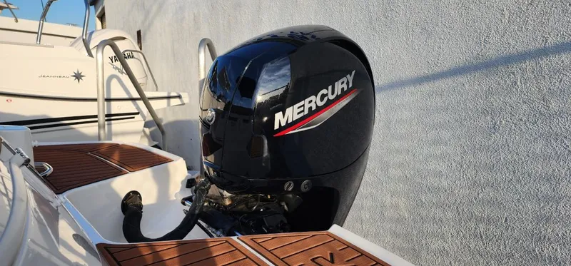 Slide: The Image of 2024 Bayliner VR6 Bowrider OB with Mercury outboard engine, docked by a wall. - 15