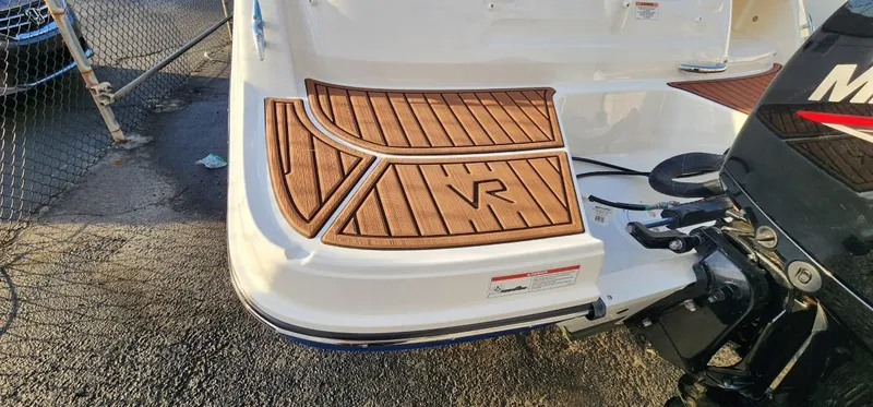 Slide: The Image of 2024 Bayliner VR6 Bowrider OB with teak-style swim platform and outboard motor. - 17