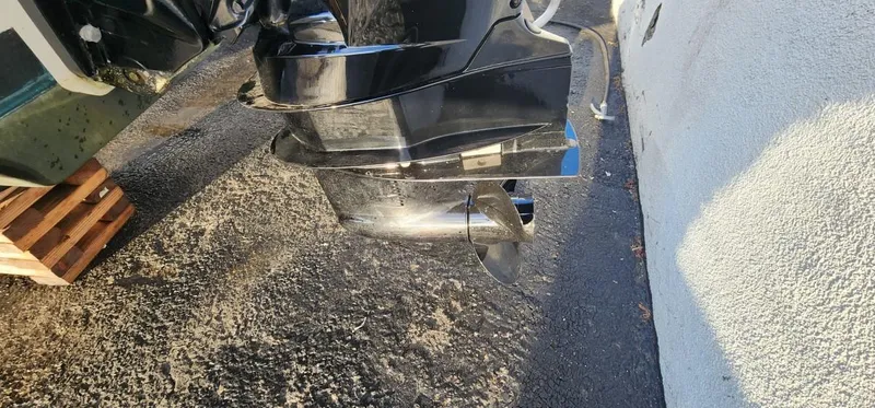 Slide: The Image of 2024 Bayliner VR6 Bowrider OB outboard motor close-up on pavement. - 19