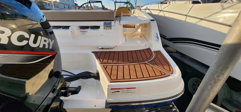 Slide: The Image of 2024 Bayliner VR6 Bowrider OB with Mercury outboard engine, featuring teak deck. - 20