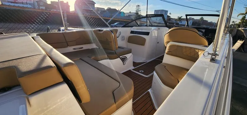 Slide: The Image of 2024 Bayliner VR6 Bowrider OB interior with tan seating and sleek design. - 23