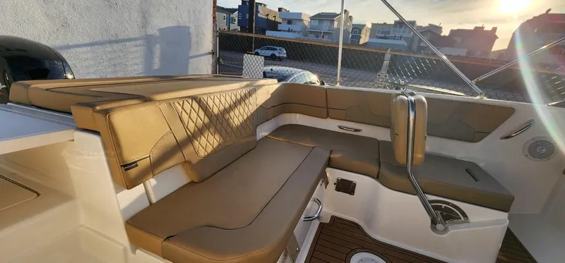 Slide: The Image of 2024 Bayliner VR6 Bowrider OB interior with tan seating and modern design. - 24