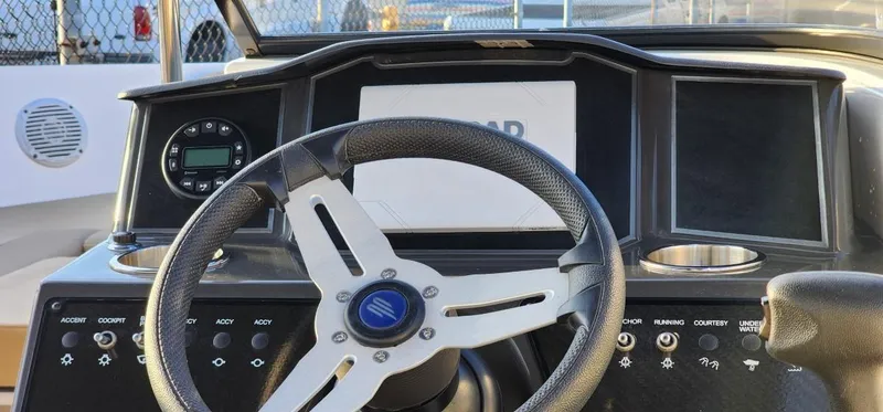 Slide: The Image of 2024 Bayliner VR6 Bowrider OB dashboard with steering wheel and controls. - 28