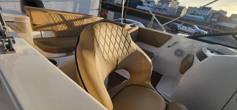 Slide: The Image of 2024 Bayliner VR6 Bowrider OB interior with tan leather seats and modern design. - 29
