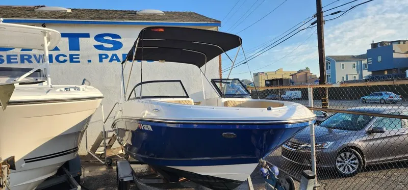 Slide: The Image of 2024 Bayliner VR6 Bowrider OB boat displayed outdoors near service center. - 33