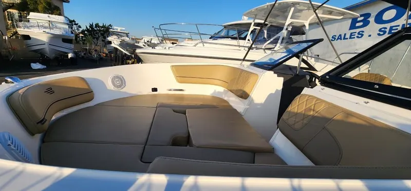 Slide: The Image of 2024 Bayliner VR6 Bowrider OB with spacious seating and modern design in a marina setting. - 36