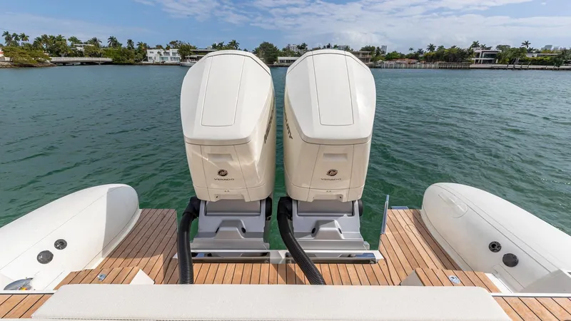 Slide: The Image of 2025 Technohull EXPLORER 40S with dual outboard engines on a wooden deck. - 11