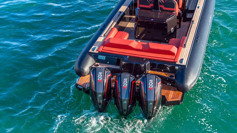 Slide: The Image of Technohull Omega 47 (2025) with triple outboard engines on blue water. - 5