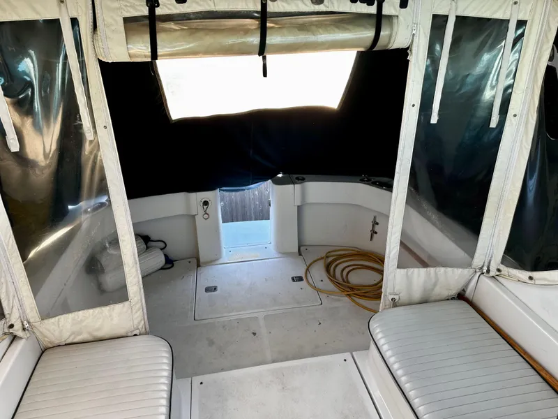 Slide: The Image of 2000 Mainship Pilot 30 Sedan interior with seating and covered windows. - 10