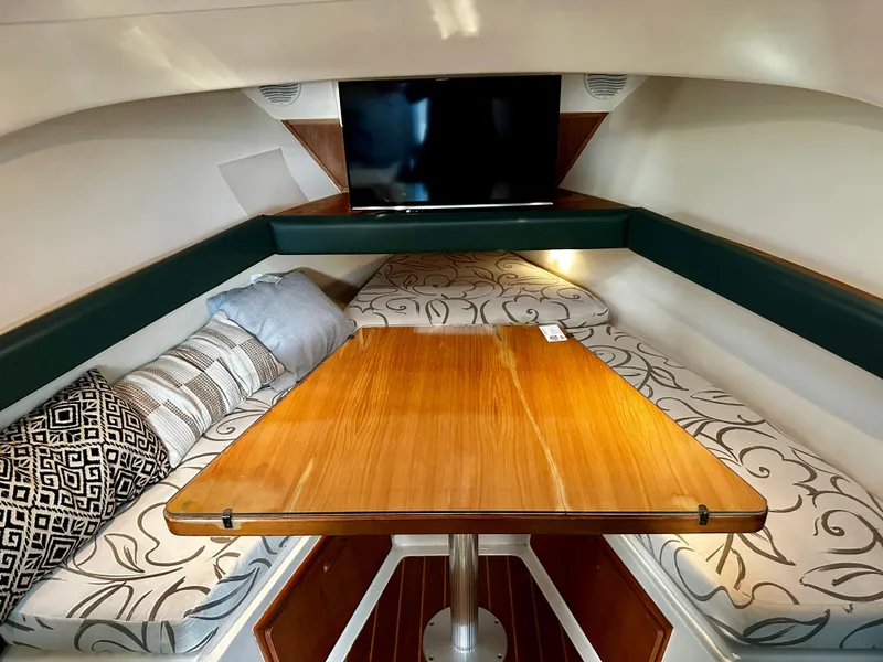 Slide: The Image of Interior of 2000 Mainship Pilot 30 Sedan with cozy seating and wooden table. - 19