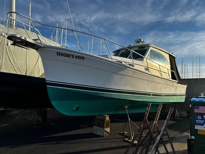 Slide: The Image of 2000 Mainship Pilot 30 Sedan boat named "Sengbe's Hope" on dry dock. - 26