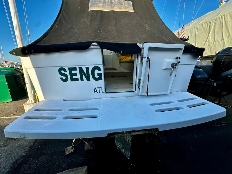 Slide: The Image of 2000 Mainship Pilot 30 Sedan boat with open rear door and swim platform. - 30