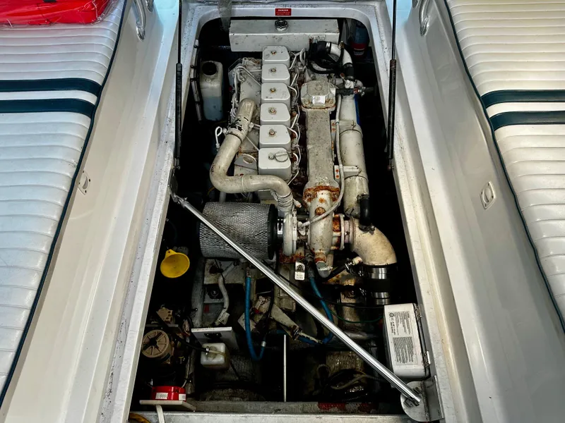 Slide: The Image of Engine compartment of a 2000 Mainship Pilot 30 Sedan boat, showcasing detailed machinery. - 33