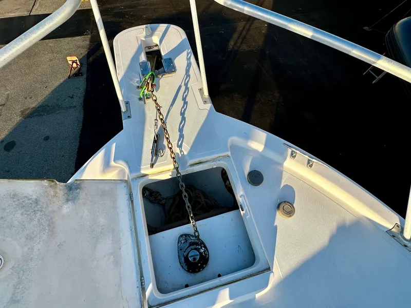 Slide: The Image of Bow of 2000 Mainship Pilot 30 Sedan with anchor chain and storage compartment. - 6