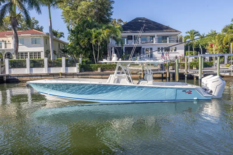 Slide: The Image of 2022 SeaVee 390Z boat docked in a scenic waterfront setting. - 0