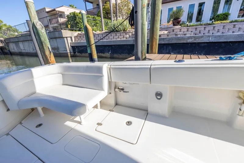 Slide: The Image of 2022 SeaVee 390Z boat interior with white seating and dock view. - 13