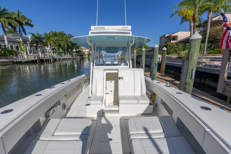 Slide: The Image of 2022 SeaVee 390Z boat docked in a sunny marina with palm trees. - 19