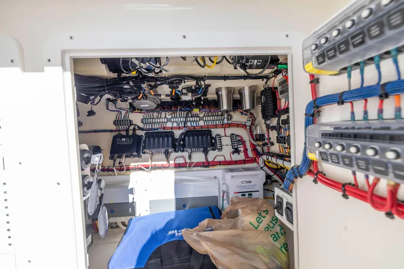 Slide: The Image of 2022 SeaVee 390Z electrical compartment with organized wiring and control panels. - 22