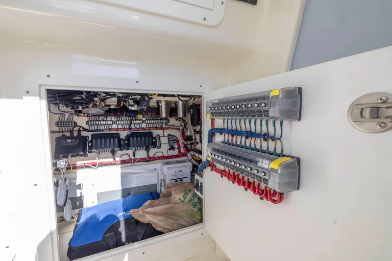 Slide: The Image of Electrical panel inside 2022 SeaVee 390Z boat, showcasing wiring and components. - 23