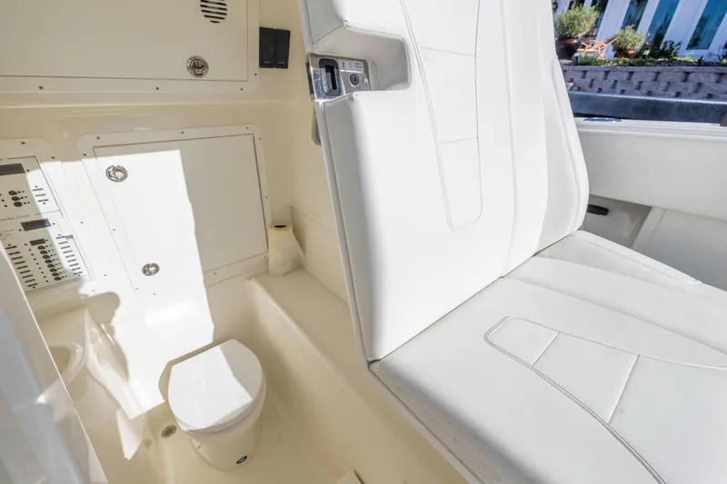 Slide: The Image of 2022 SeaVee 390Z boat interior with white seating and compact toilet. - 24
