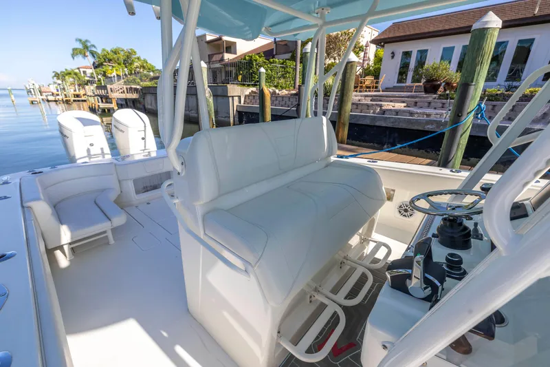 Slide: The Image of 2022 SeaVee 390Z boat interior with helm, seating, and docked waterfront view. - 26