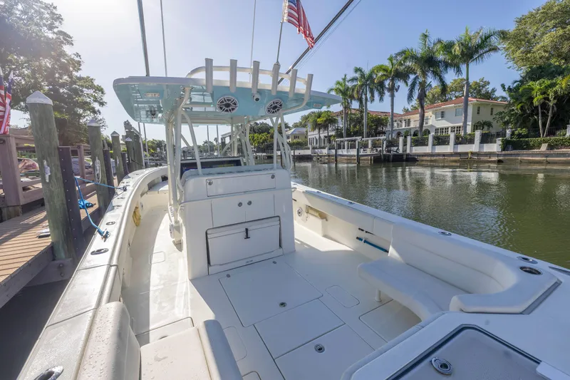 Slide: The Image of 2022 SeaVee 390Z boat docked by a scenic canal with palm trees. - 28