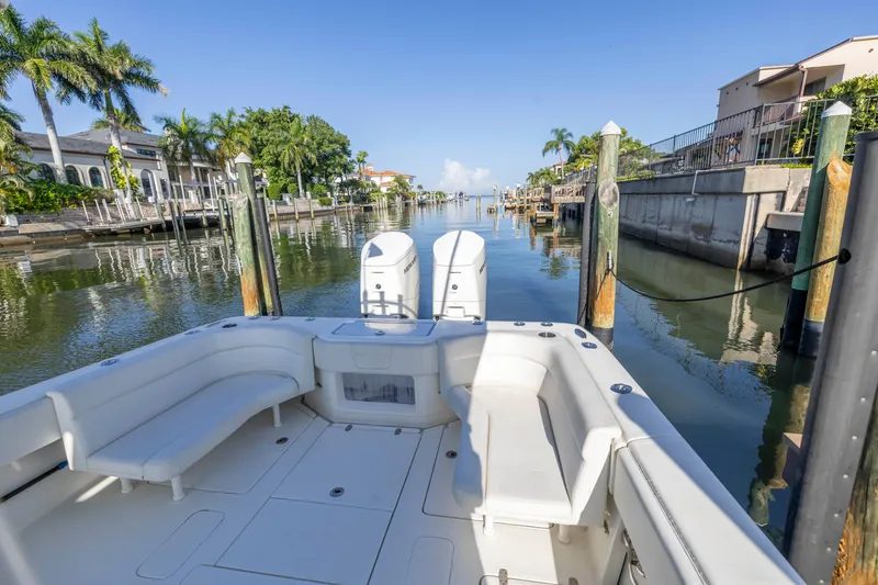 Slide: The Image of 2022 SeaVee 390Z boat docked in a scenic canal with palm trees. - 32