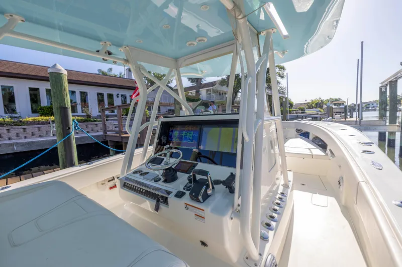 Slide: The Image of 2022 SeaVee 390Z boat cockpit with modern navigation equipment at a marina. - 35